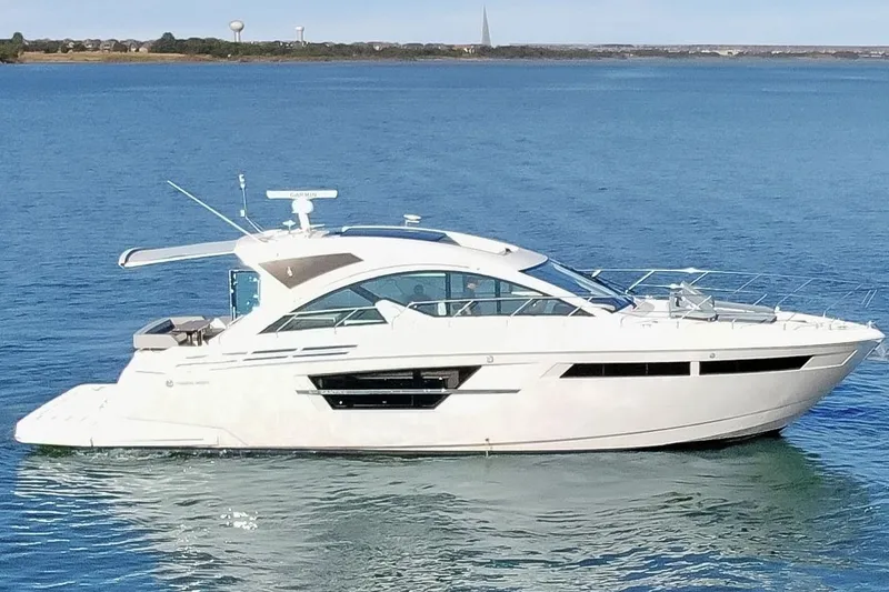 Slide: The Image of 2022 Cruisers Yachts 54 Cantius luxury yacht on calm blue water. - 4