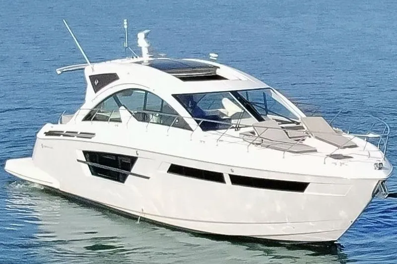 Slide: The Image of 2022 Cruisers Yachts 54 Cantius luxury yacht on calm blue water. - 5