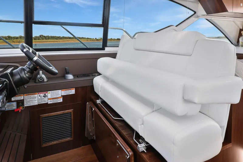 Slide: The Image of 2022 Cruisers Yachts 54 Cantius helm with white seating and scenic window view. - 57
