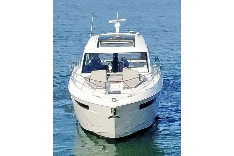 Slide: The Image of 2022 Cruisers Yachts 54 Cantius on calm blue water, front view. - 6