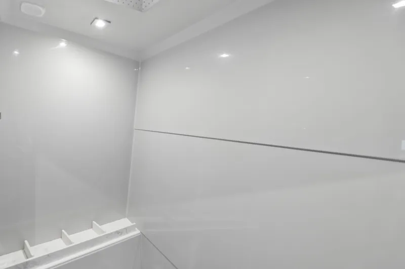 Slide: The Image of Modern interior of 2022 Cruisers Yachts 54 Cantius, featuring sleek white walls and recessed lighting. - 64