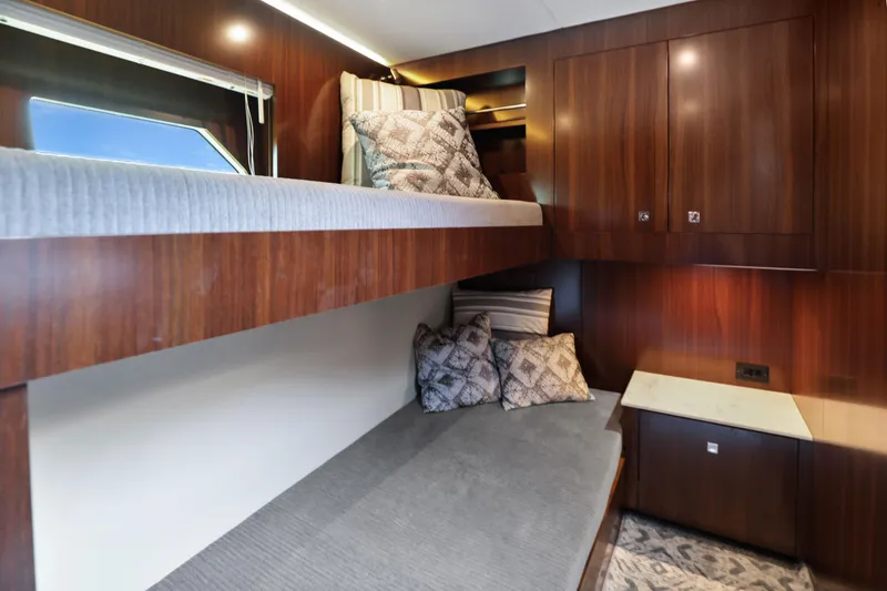 Slide: The Image of 2022 Cruisers Yachts 54 Cantius cabin with bunk beds and wooden cabinetry. - 72
