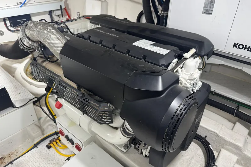 Slide: The Image of Engine room of 2022 Cruisers Yachts 54 Cantius, featuring a modern engine setup. - 76
