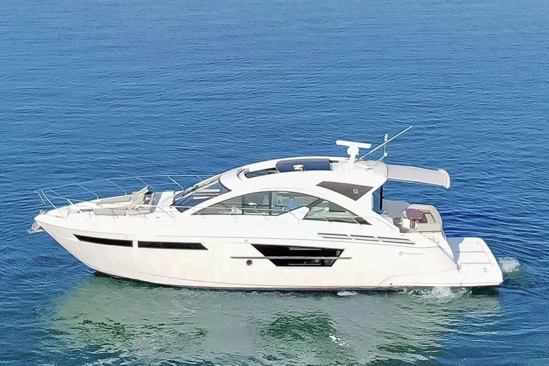 Slide: The Image of 2022 Cruisers Yachts 54 Cantius on calm blue water. - 8