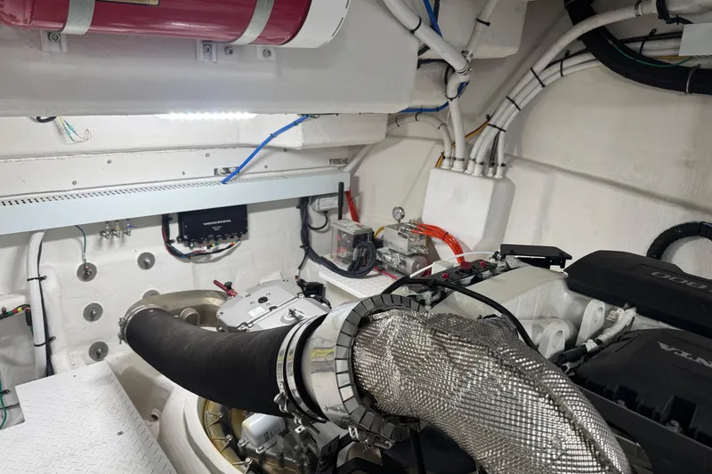 Slide: The Image of Engine room of 2022 Cruisers Yachts 54 Cantius, showcasing mechanical components and wiring. - 83