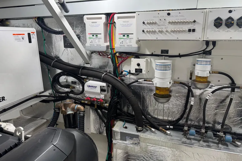 Slide: The Image of Engine room of 2022 Cruisers Yachts 54 Cantius with control panels and wiring. - 87