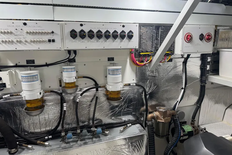 Slide: The Image of Engine room of 2022 Cruisers Yachts 54 Cantius with control panels and fuel filters. - 88