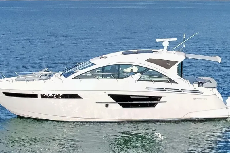 The Image of 2022 Cruisers Yachts 54 Cantius luxury yacht on calm blue water. - 0