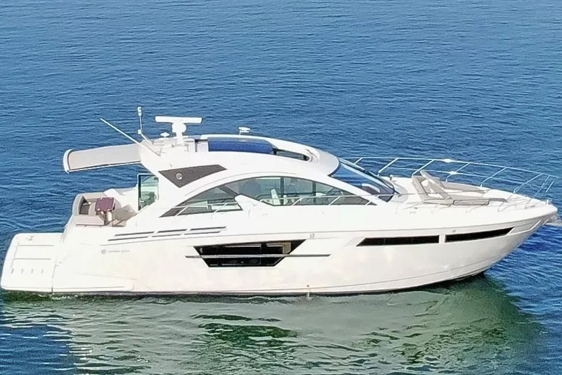 Slide: The Image of 2022 Cruisers Yachts 54 Cantius luxury yacht on calm blue water. - 12