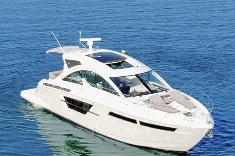 Slide: The Image of 2022 Cruisers Yachts 54 Cantius on calm blue water. - 13