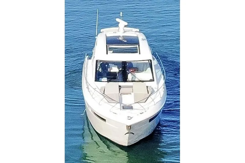Slide: The Image of 2022 Cruisers Yachts 54 Cantius on calm water, front view. - 14