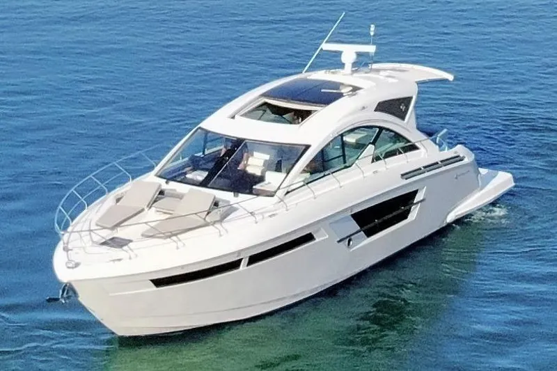 Slide: The Image of 2022 Cruisers Yachts 54 Cantius luxury yacht on clear blue water. - 15