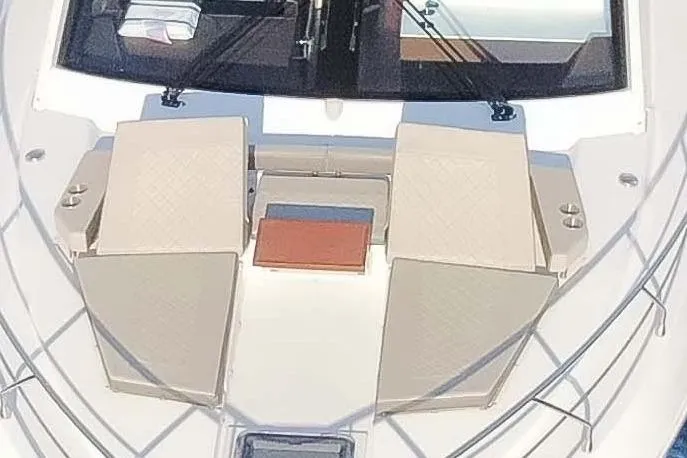 Slide: The Image of 2022 Cruisers Yachts 54 Cantius deck with sun loungers and sleek design. - 17