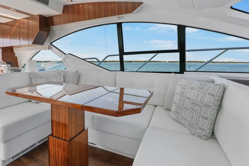 Slide: The Image of Luxurious interior of 2022 Cruisers Yachts 54 Cantius with elegant seating and wooden table. - 39