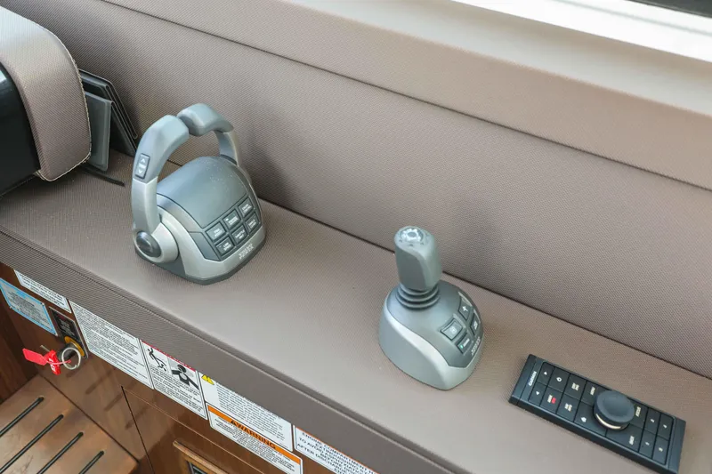 Slide: The Image of Control panel of 2022 Cruisers Yachts 54 Cantius with joystick and throttle. - 52