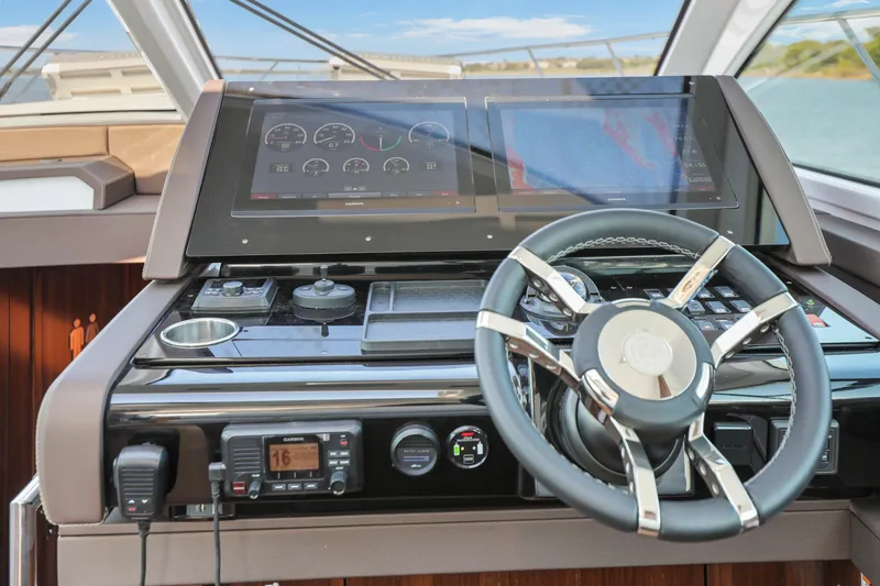 Slide: The Image of Helm of 2022 Cruisers Yachts 54 Cantius with modern navigation displays and controls. - 55