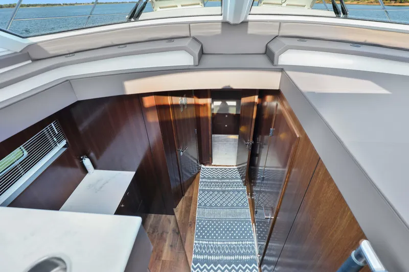 Slide: The Image of Luxurious interior of 2022 Cruisers Yachts 54 Cantius with elegant wood finishes. - 59