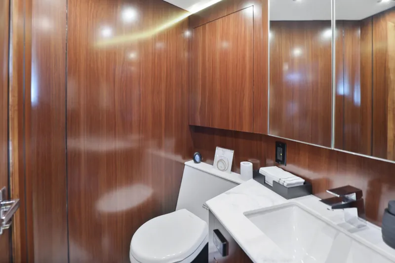 Slide: The Image of Luxurious 2022 Cruisers Yachts 54 Cantius bathroom with wood paneling and modern fixtures. - 63