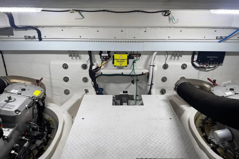 Slide: The Image of Engine room of 2022 Cruisers Yachts 54 Cantius, featuring modern equipment and wiring. - 82