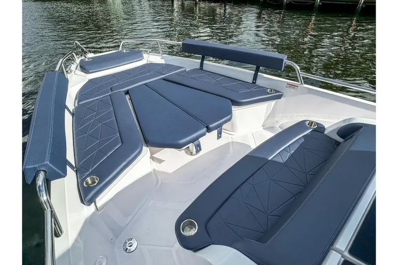 Slide: The Image of Luxurious seating area on 2026 Axopar 29 Sun Top boat with blue cushions. - 18