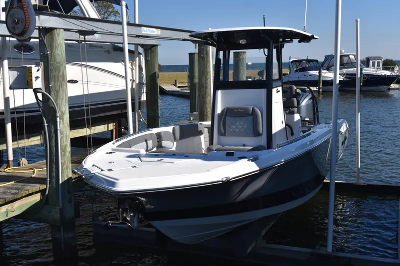 Slide: The Image of 2025 NauticStar 251 Hybrid boat docked at marina, showcasing sleek design and modern features. - 12