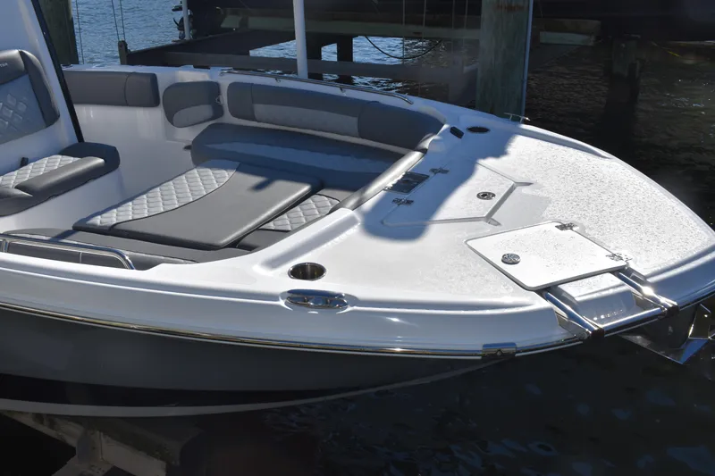 Slide: The Image of 2025 NauticStar 251 Hybrid boat with cushioned seating and sleek design on the water. - 13