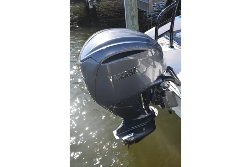 Slide: The Image of Yamaha outboard motor on 2025 NauticStar 251 Hybrid boat, docked in water. - 16