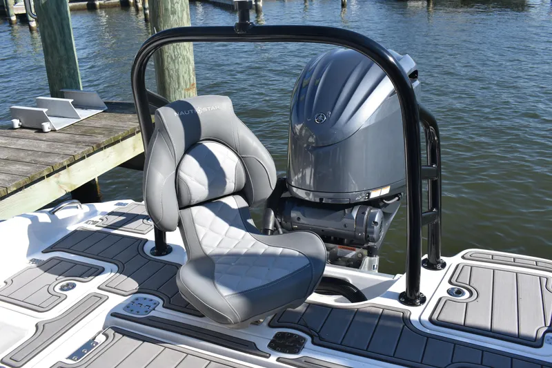 Slide: The Image of 2025 NauticStar 251 Hybrid boat with sleek seating and powerful engine at dock. - 17