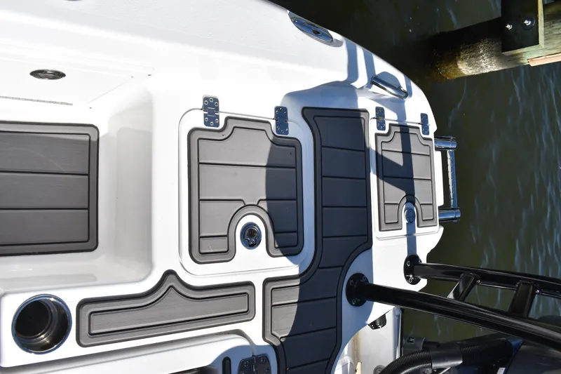 Slide: The Image of 2025 NauticStar 251 Hybrid boat deck with storage compartments and sleek design. - 18