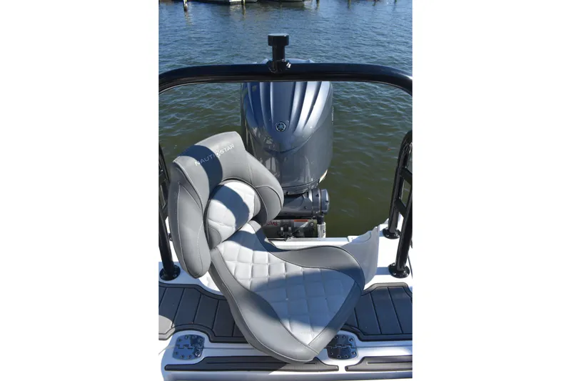 Slide: The Image of 2025 NauticStar 251 Hybrid boat seat and engine on water. - 22