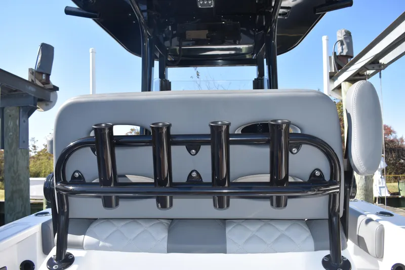 Slide: The Image of 2025 NauticStar 251 Hybrid boat with rod holders and cushioned seating. - 23