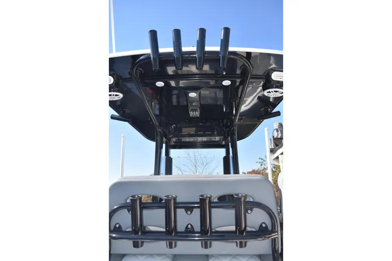 Slide: The Image of 2025 NauticStar 251 Hybrid boat, featuring a sleek black T-top and rod holders. - 24