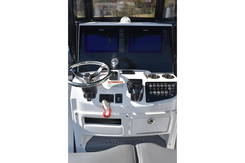 Slide: The Image of 2025 NauticStar 251 Hybrid boat dashboard with steering wheel and control panel. - 27