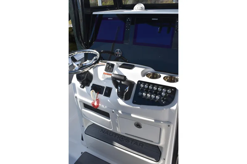 Slide: The Image of 2025 NauticStar 251 Hybrid boat console with steering wheel and control panel. - 33