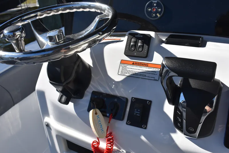 Slide: The Image of 2025 NauticStar 251 Hybrid boat dashboard with steering wheel and controls. - 35