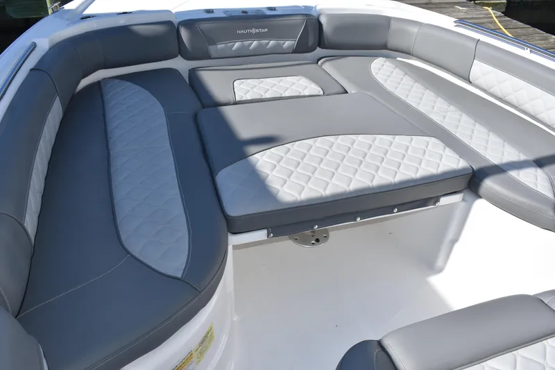 Slide: The Image of 2025 NauticStar 251 Hybrid boat interior with gray and white cushioned seating. - 41