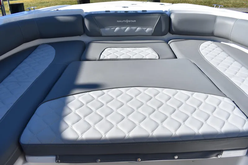 Slide: The Image of 2025 NauticStar 251 Hybrid boat interior with gray and white cushioned seating. - 46