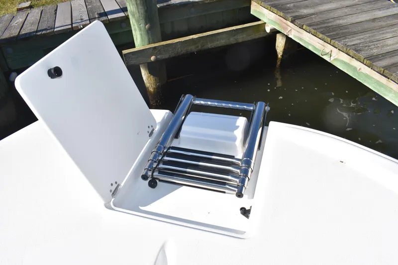 Slide: The Image of 2025 NauticStar 251 Hybrid boat with a foldable stainless steel ladder on deck. - 50