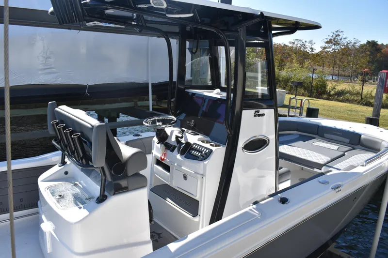 Slide: The Image of 2025 NauticStar 251 Hybrid boat interior with modern console and seating. - 59