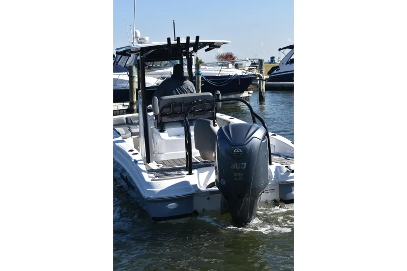 Slide: The Image of 2025 NauticStar 251 Hybrid boat with powerful outboard engine in marina. - 71