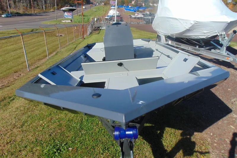 Slide: The Image of 2026 Crestliner 2070 Retriever CC boat on display, featuring open storage compartments. - 7