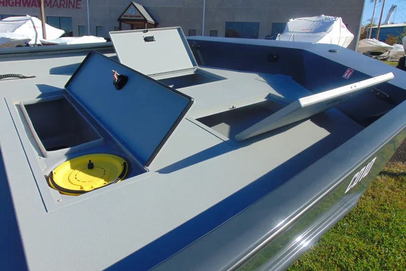 Slide: The Image of 2026 Crestliner 2070 Retriever CC boat with open storage compartments and yellow hatch. - 8