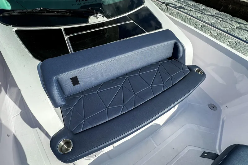 Slide: The Image of 2026 Axopar 29 Sun Top boat seat with geometric design and cup holders. - 10