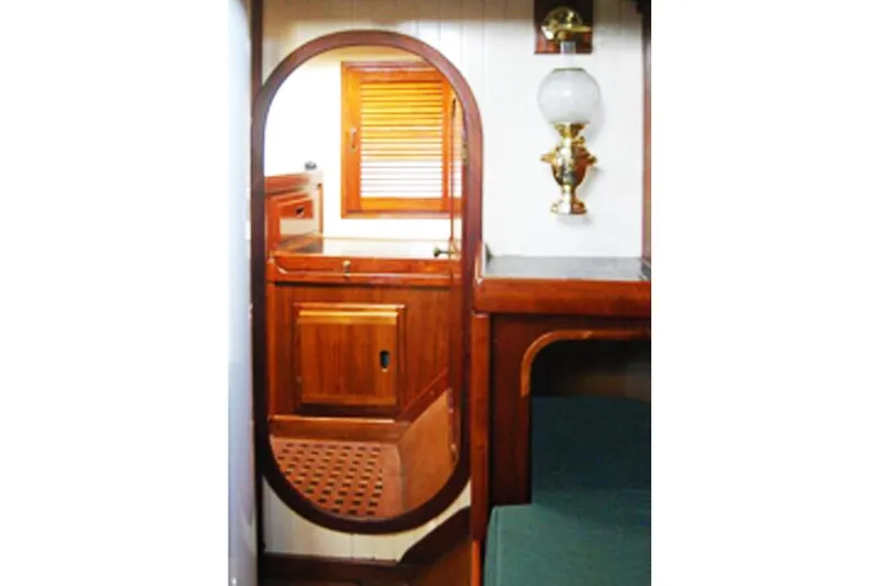Slide: The Image of Interior of 1985 Sam L. Morse Bristol Channel Cutter 28, featuring wooden cabinetry and nautical decor. - 10
