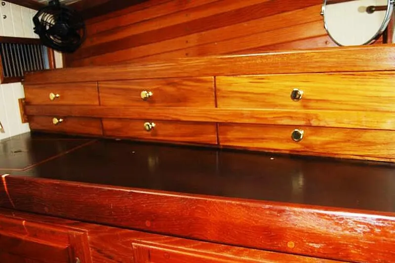 Slide: The Image of Wooden interior of 1985 Sam L. Morse Bristol Channel Cutter 28 with drawers and brass knobs. - 13