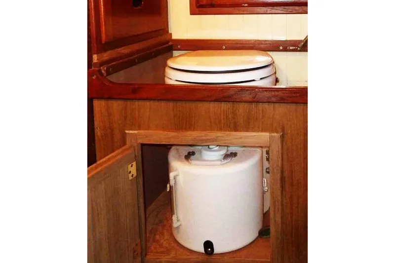 Slide: The Image of 1985 Sam L. Morse Bristol Channel Cutter 28 interior with marine toilet and storage compartment. - 14