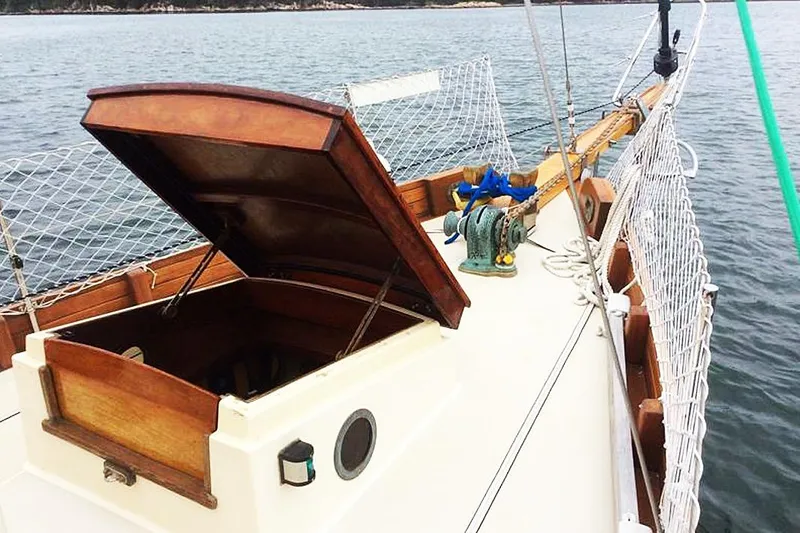 Slide: The Image of 1985 Sam L. Morse Bristol Channel Cutter 28 sailboat with open hatch on calm water. - 3