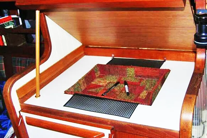 Slide: The Image of Interior of 1985 Sam L. Morse Bristol Channel Cutter 28, featuring a wooden navigation desk. - 8