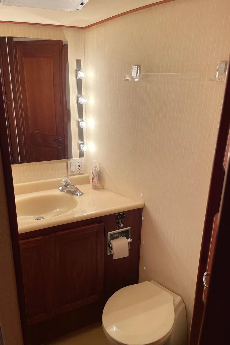 Slide: The Image of 1988 Viking Boats 41 Convertible bathroom with sink, mirror, and toilet. - 34
