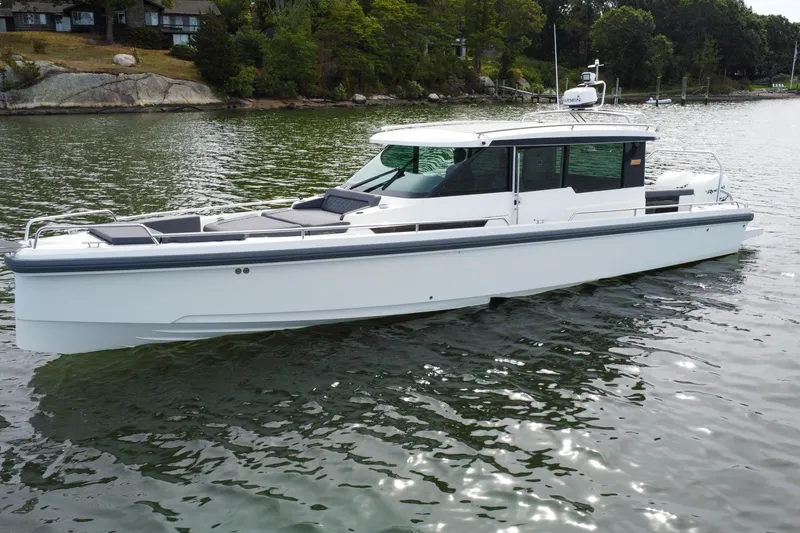 The Image of 2018 Axopar 37 Sport Cabin R on calm water, showcasing sleek design and modern features. - 0